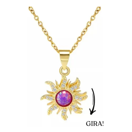 Dije de sol en color dorado con una piedra central MORADA brillante, sobre una cadena GIRATORIA.