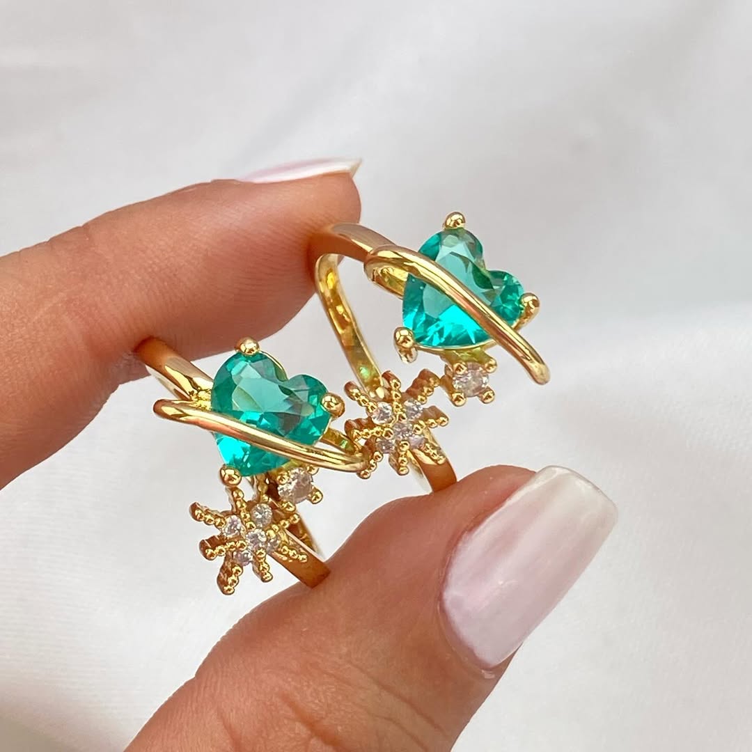 Anillo ajustable del Corazón Cósmico en acabado dorado con piedras en forma de corazón y estrellas. aquamarina